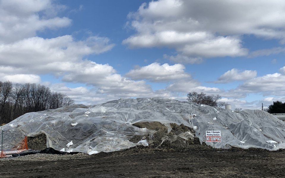 Mounds of soil covered with a tarp