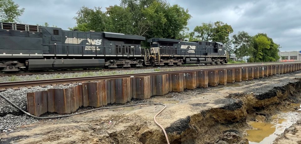 The South Ditch is de-watered before excavation continues with train passing in the background