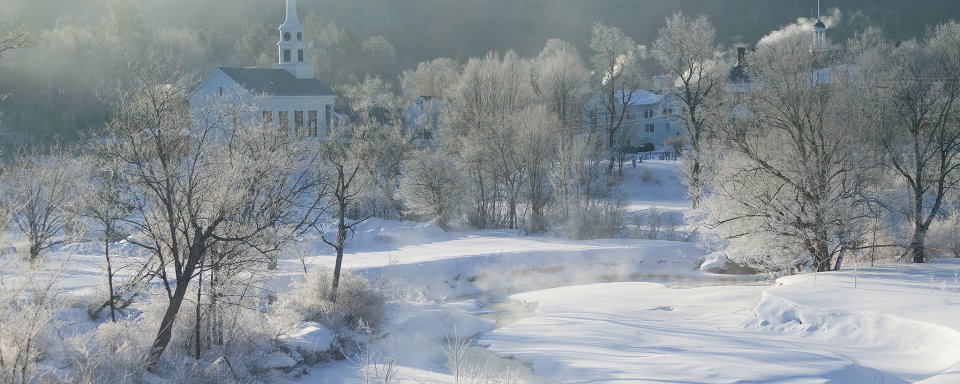 Sunrise over community church on a cold winter morning in Stowe, Vermont