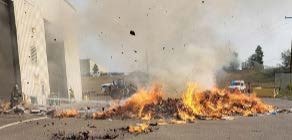 Photo of a firefighter extinguishing a lithium battery fire after the combusted pile of recyclables was moved outside by a municipal recycling facility operator. Photo courtesy of Larimer County Solid Waste Department, Colorado.