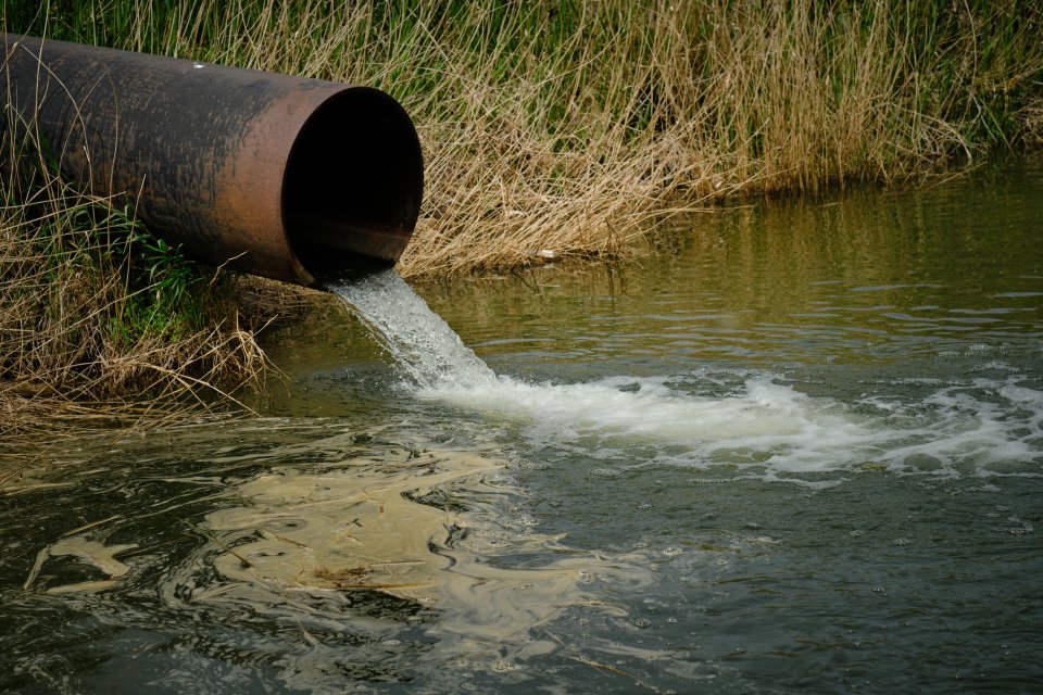 Pipe dumping wastewater into stream.