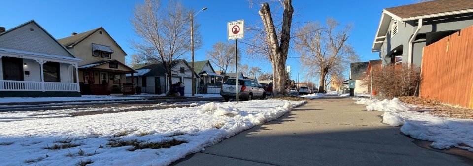 Neighborhood street on a winters day as snow melts on the streets in Pueblo Colorado