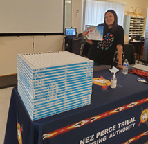 A woman standing next to a stack of air filters on a table