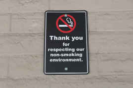 a no smoking sign on outside a buidling.