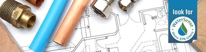 Schematics on a table with tools.