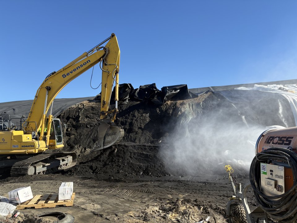 dozer picking up slag with fan