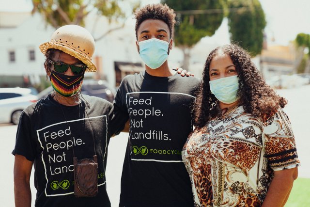 Image of a group of three volunteers standing together for a group photo.