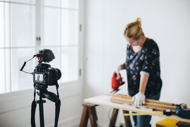 Women filming herself doing a DIY project