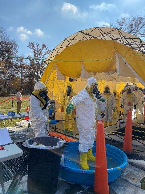 Samplers walking through the line where diluted bleach was applied to all PPE.