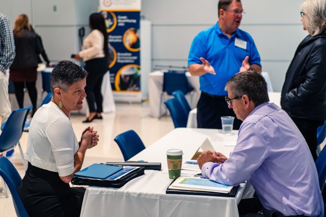 Two people sitting at a table having a planning conversation