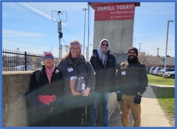 EPA Region 5’s Kathy Kowal, Sheila Batka, Rich Baldauf and Parik Deshmukh pose outside next to one of the school’s fixed monitoring sites.