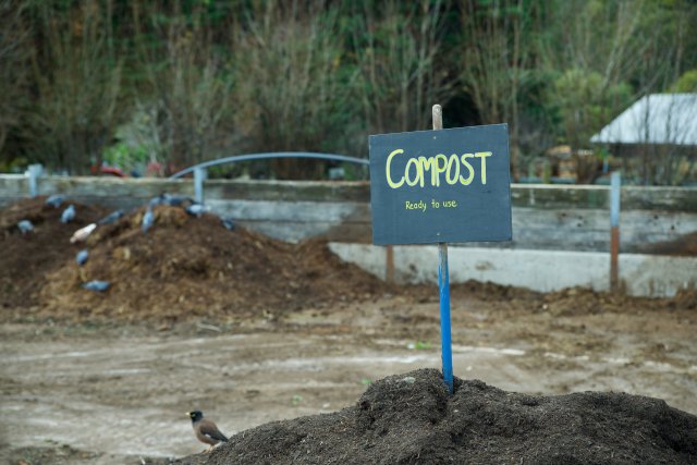 Sign in a pile of finished compost reading "Ready to use"