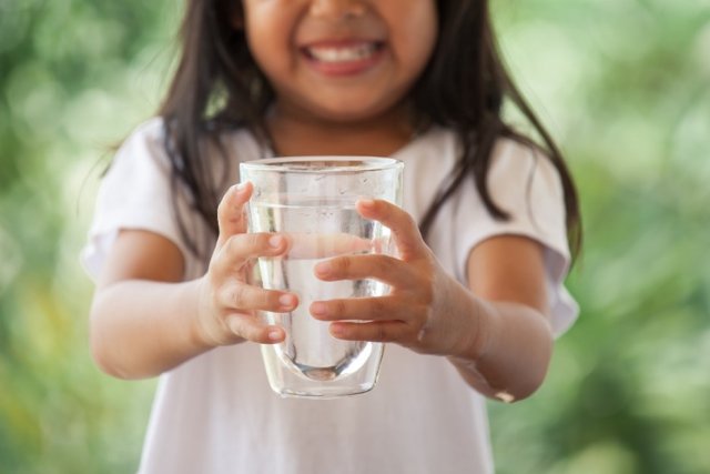 Girl holding water glass