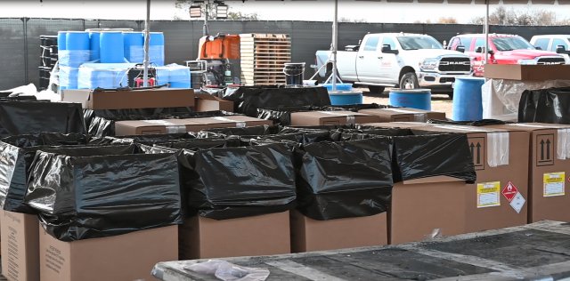 Waste containers that are lined with heavy plastic at an EPA staging area.
