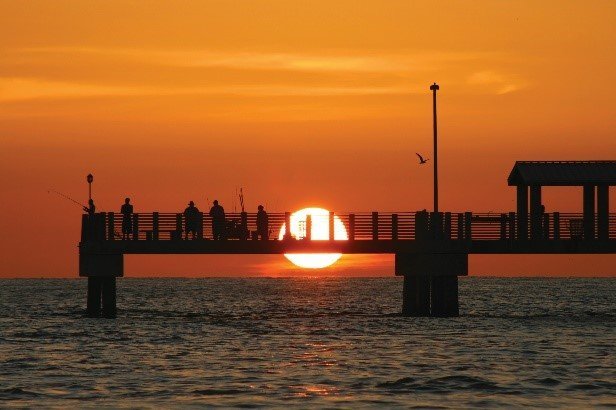 The sun setting behind a dock