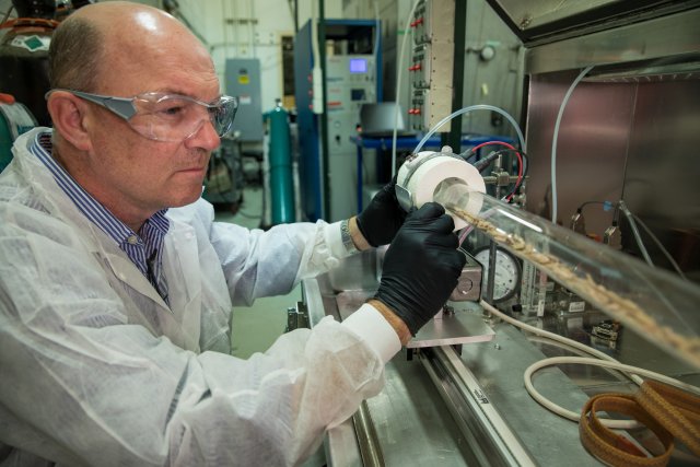 Researcher using automated furnace system.