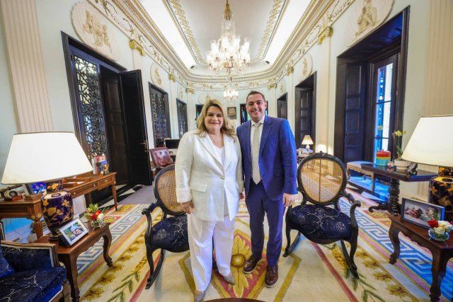 A photo of two people posing in a nicely decorated room