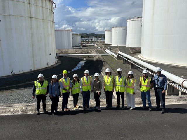 Photo: EPA RA Martucci and other EPA officials visit the CAPECO site in Puerto Rico and pose for a photo in front of the tanks.