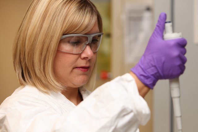 Researcher taking measurements in the lab