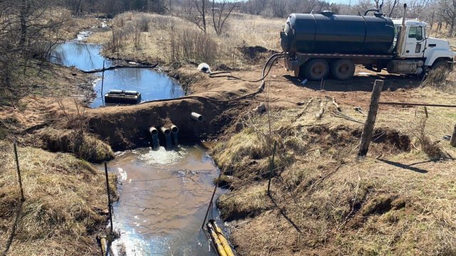 "After" image of an underflow dam, used to separate oil from water, operating on the Chikaskia River. The water is this photo is noticeably clearer than in image taken five days earlier.