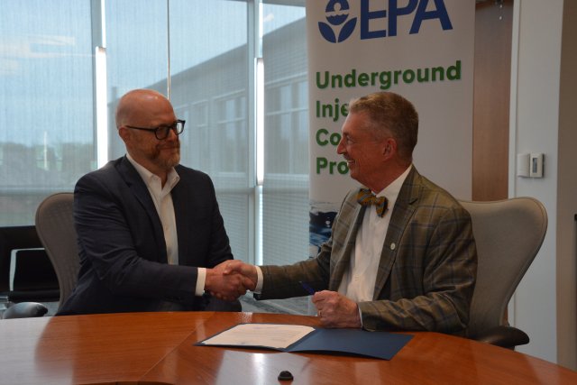 EPA Region 7 Administrator Jim Macy shakes hands with PureField Carbon Capture Chief Executive Officer Aaron Buettner after signing a permit.
