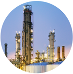 twilight view of industrial facility with six towers visible