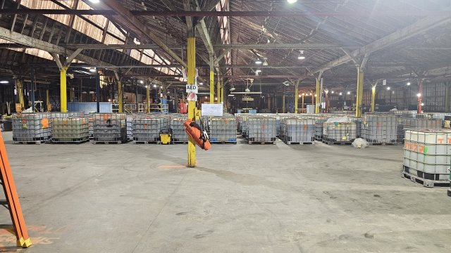 Before photo of vats of chemicals used in the electroplating process, containers that the hazardous waste is stored in and, lastly, security measures in place.