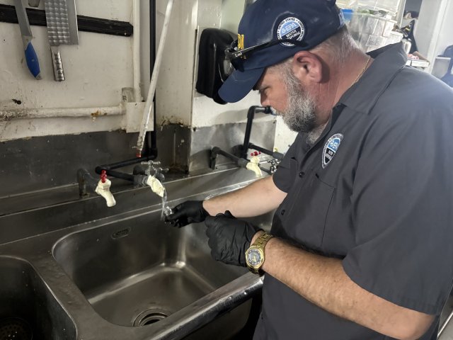 EPA staff sampling drinking water at a restaurant faucet in Saipan.