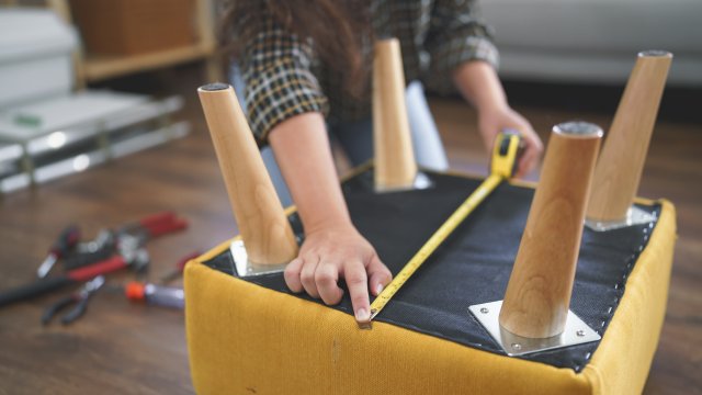 person refinishing a chair