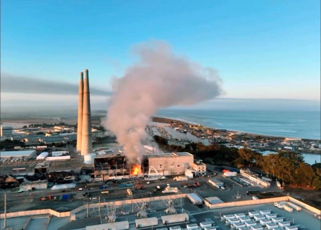 Aerial photograph showing fire and smoke coming from Moss Landing Building 300