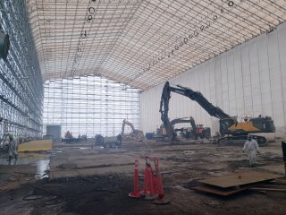 Interior of Segment 3 building showing only the surrounding tent remaining after the walls were completely deconstructed. Rubble and dirt visible on the ground.