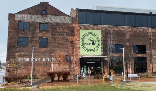 Large brick building with the words Outdoor Adnture Center on it