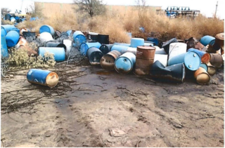 photo of rusting drums in an open field