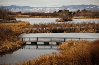 Photograph of a lake with a foot bridge connecting two pieces of land