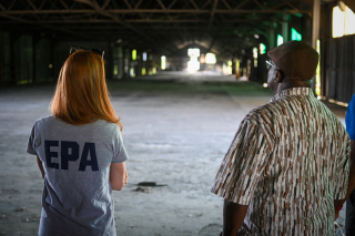 Two people looking down huge warehouse