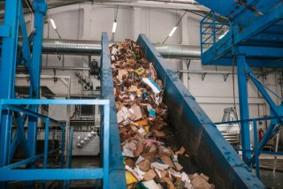 conveyor belt with recyclables on it at a recycling facility