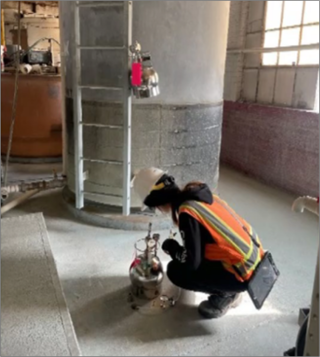 Person checking sampling canister