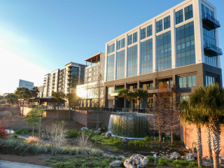 A building with a fountain in front of it.