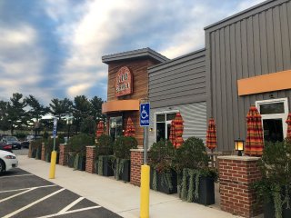 The exterior of a restaurant with outdoor seating.