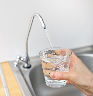 Photo of a glass being filled with water from a faucet