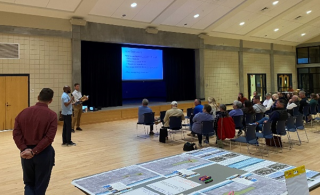 A group of people watching a presentation.