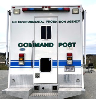 Back of a large RV like vehicle with painted text "U.S. EPA Command Post"