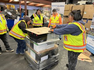 Responsible Battery Coalition and Backhaul Alaska staff undergo training in Anchorage by stacking batteries onto a pallet.