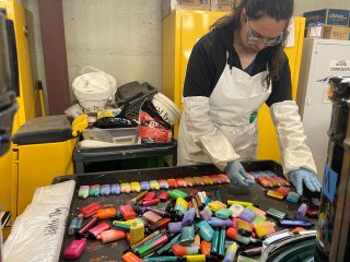 An employee sorts e-cigarettes collected from schools and vape shops