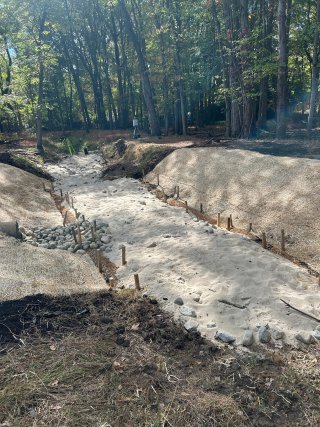 Excavated stream bed with refilled clean soil.