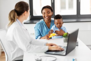 Doctor consults with mother and child