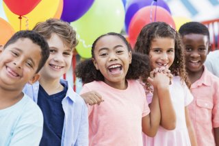 Children smiling with balloons