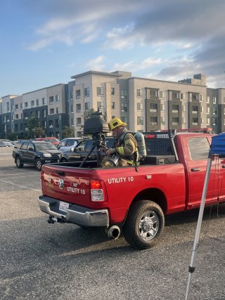 Firefighter in the back of a red pickup truck in Garden Grove, California