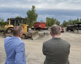 Two men observe progress at a brownfields redevelopment project.