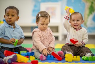 Three children playing with blocks